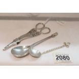 A pair of silver grape scissors, a silver spoon with lion finial and a silver spoon with twist stem.