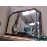 A framed mantel mirror