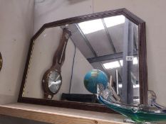 A framed mantel mirror