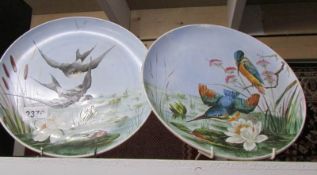 A pair of cabinet plated hand painted with birds.
