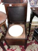 A mahogany commode complete with pot