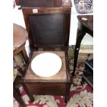 A mahogany commode complete with pot