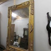A heavy gilt framed mirror (mirror 121 x 70 cm, frame 152 x 99 cm).