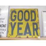 A painted board sign advertising 'Good Year'