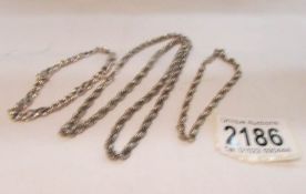 A silver chain with matching wrist chain and a silver cross fetter link wrist chain,.