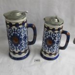 2 graduated Doulton Burslem pitchers with metal lids (one lid a/f).