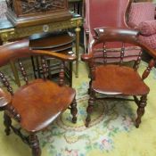 A pair of oak captain's chairs.