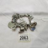 A silver charm bracelet with 20 silver and white metal charms.