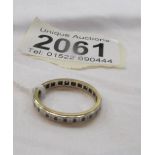 A yellow metal eternity ring.