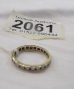 A yellow metal eternity ring.