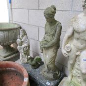2 garden statues, a pigeon and a bench,