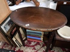 An oval carved side table with under gallery