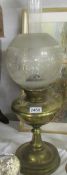 A Victorian brass oil lamp with original shade.