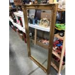 A bevel edged mirror in gilt frame