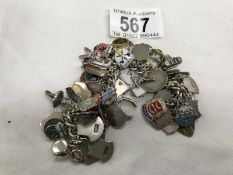 A charm bracelet with mainly silver charms & silver travel tokens (weight 112gms)