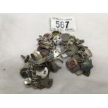 A charm bracelet with mainly silver charms & silver travel tokens (weight 112gms)