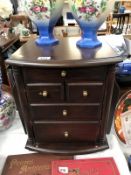 A 5 drawer cabinet with magazine racks on side