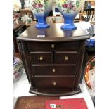 A 5 drawer cabinet with magazine racks on side