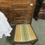 A mahogany inlaid nursing chair.