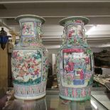 A pair of late 19th / early 20th century Chinese famille rose baluster vases depicting 2 panels of