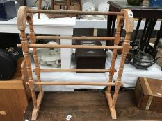 A carved wood spindle clothes horse