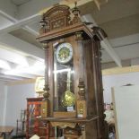 A wall clock with brass decoration and musical chime.