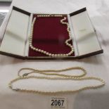 A pearl necklace with gold clasp and 2 other pearl necklaces.