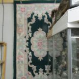 A dark green and pink patterned rug.