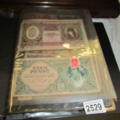 A folder of assorted bank notes.