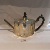 A hall marked silver teapot.