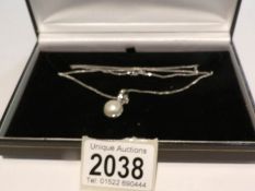 A 14ct white gold pendant set pearl (hall marked RAM London 2000) and a 9ct white gold chain marked