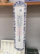 A blue and white pottery garden thermometer