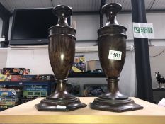 A pair of oak urn shaped candlesticks