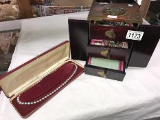 An Oriental style jewellery box containing an assortment of costume jewellery & case set of faux