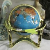 A large gem set table globe on brass base.