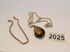 2 9ct gold chains (approximately 8 grams) and a smoky quartz pendant with 9ct gold mount.