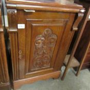 A good oak cabinet with carved door.