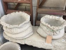 2 concrete planters in the shape of sacks