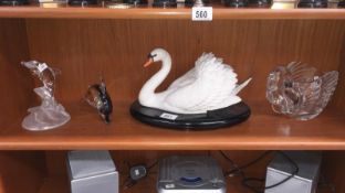 2 swan figures and 2 dolphin figures