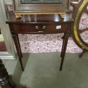 A mahogany effect hall table with drawer.