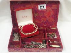 A mixed lot of costume jewellery including earrings, brooches, cuff links, tie pins,