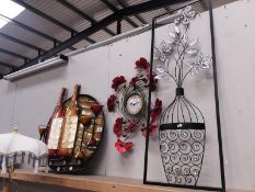 A metal poppy wall clock and 2 wall ornaments.