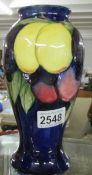 A Moorcroft wisteria vase, approx. 9" / 22.75 cm tall.