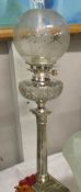 A silver plated Corinthian column oil lamp with cut glass font and etched glass shade.