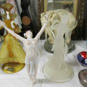An Egyptian style semi nude figure and a resin figure.