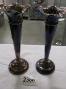 A pair of silver spill vases.
