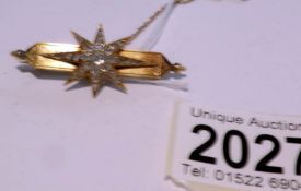 A 15ct gold brooch set with diamonds in a star, approximately 6 grams.