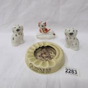 A Guinness ashtray, a pair of miniature Staffordshire spaniels and one other Staffordshire spaniel.