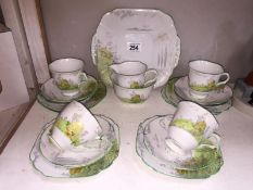 A Melba china tea set with cottage scene