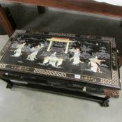 A superb quality oriental coffee table decorated with mother or pearl figures.